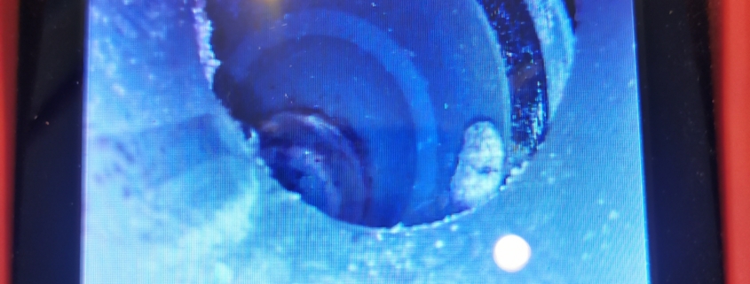 Diagnostyka wnętrza rury kanalizacyjnej – widoczne uszkodzenie mechaniczne rury.