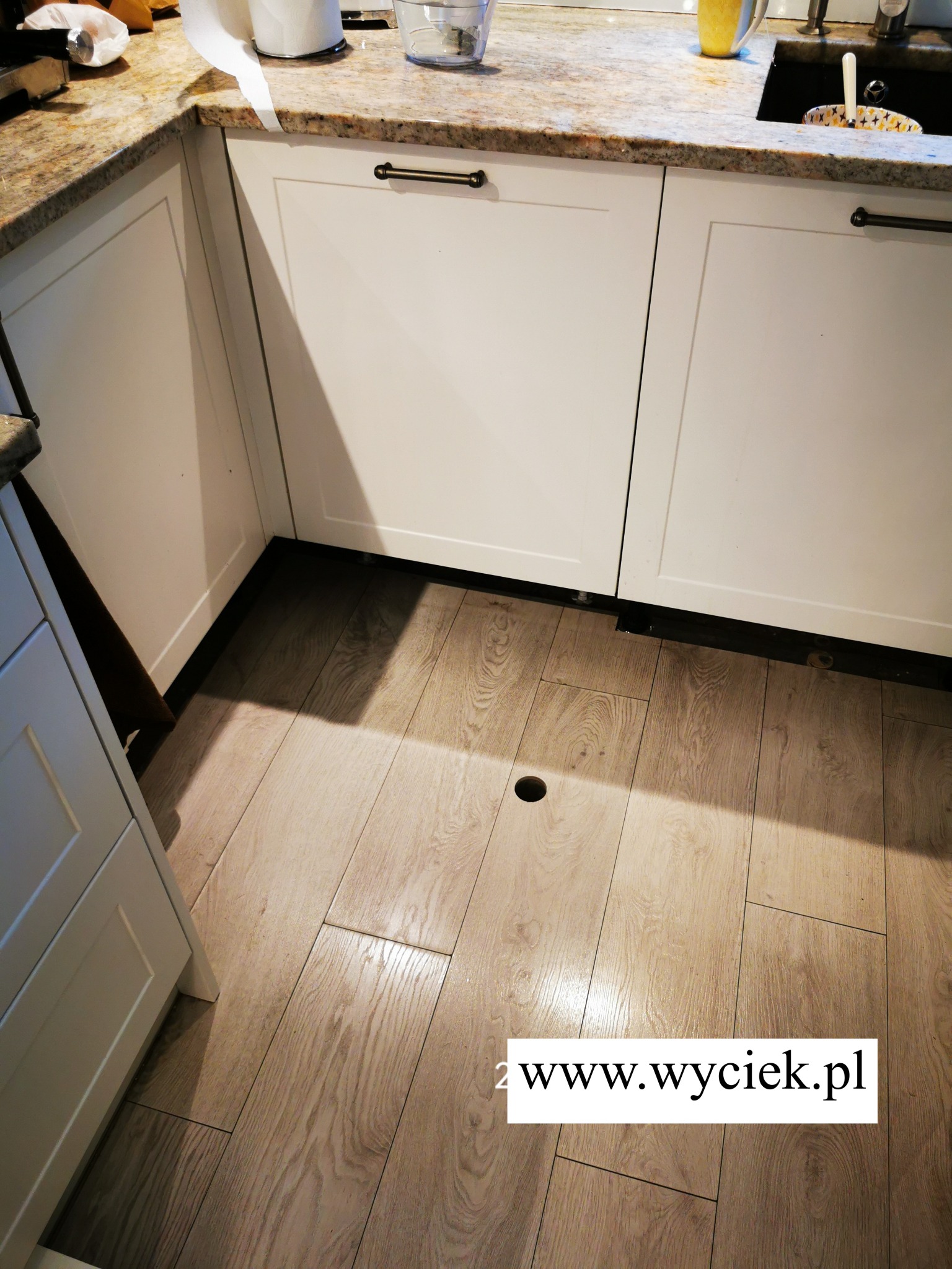 Otwór technologiczny w podłodze kuchni wykonany do osuszania podposadzkowego