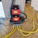 Woda pod posadzką po zalaniu mieszkania i przygotowanie do pomiarów wilgoci